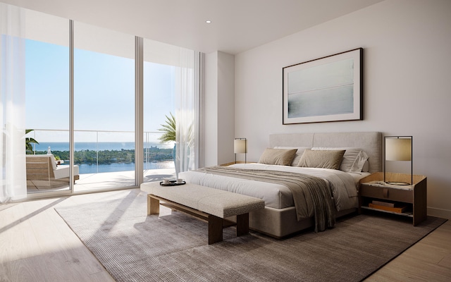 bedroom with a water view, access to outside, and wood-type flooring