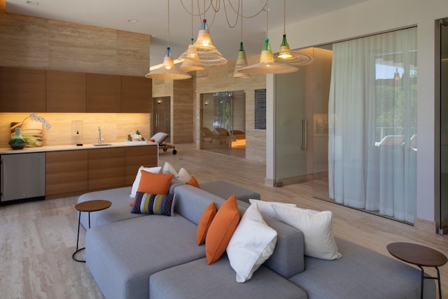 living room with sink and light hardwood / wood-style flooring