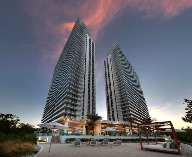 view of outdoor building at dusk