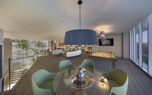 carpeted dining area featuring expansive windows