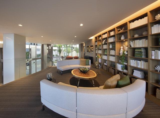 living room with a fireplace and floor to ceiling windows