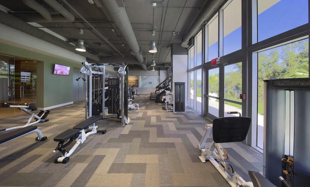 gym with dark colored carpet and french doors