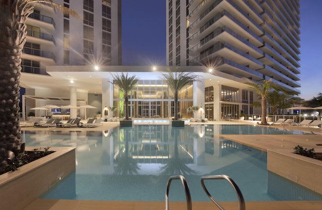 view of pool at dusk