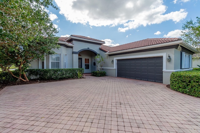 mediterranean / spanish-style home featuring a garage