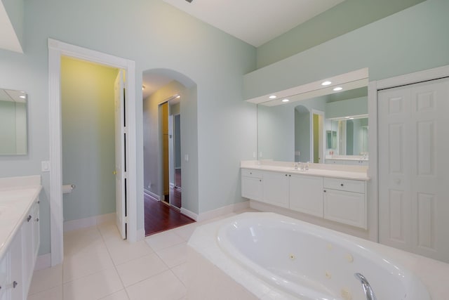 bathroom with vanity, plus walk in shower, and tile patterned flooring