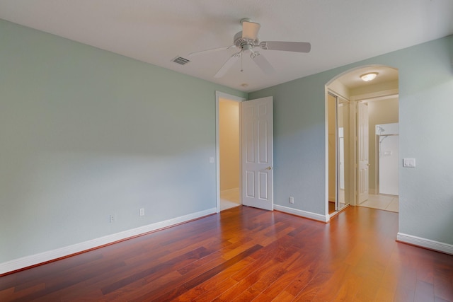 empty room with hardwood / wood-style flooring and ceiling fan