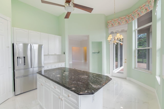 kitchen with white cabinets, decorative backsplash, dark stone counters, a center island, and stainless steel fridge with ice dispenser