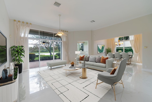 living room featuring an inviting chandelier and a healthy amount of sunlight