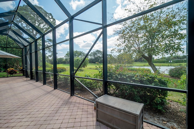 unfurnished sunroom featuring a water view