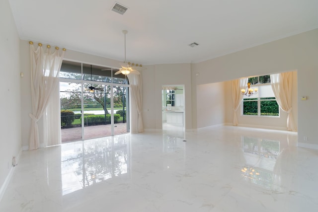 spare room with ceiling fan with notable chandelier