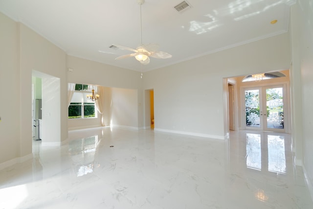 empty room with ceiling fan with notable chandelier, ornamental molding, and french doors