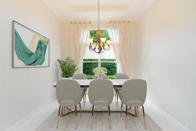 dining area featuring a tray ceiling and a chandelier