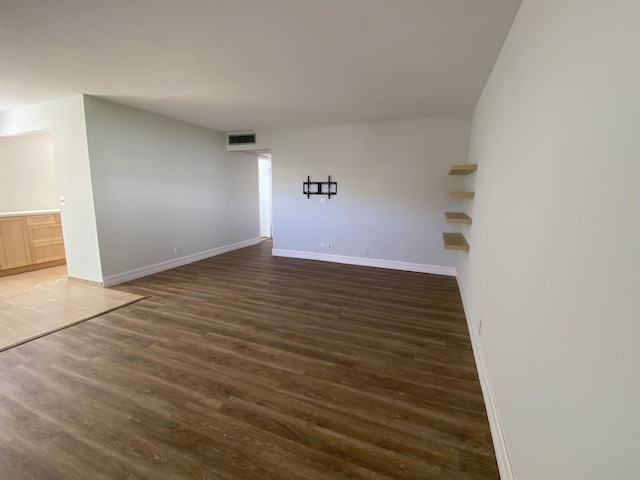 empty room with dark wood-type flooring