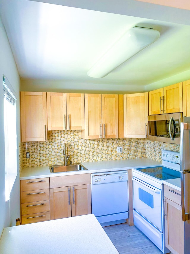 kitchen featuring tasteful backsplash, stainless steel appliances, sink, and light brown cabinets