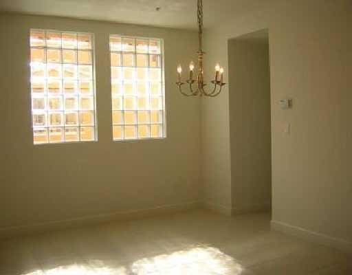 unfurnished room with a wealth of natural light and a chandelier