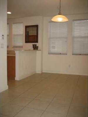 unfurnished room with tile floors