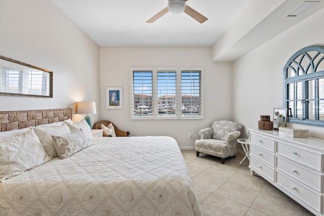 bedroom with ceiling fan and light tile patterned floors