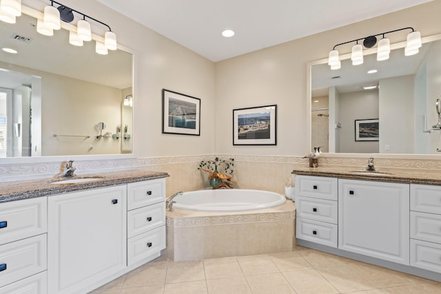 bathroom featuring tile patterned flooring, vanity, and plus walk in shower