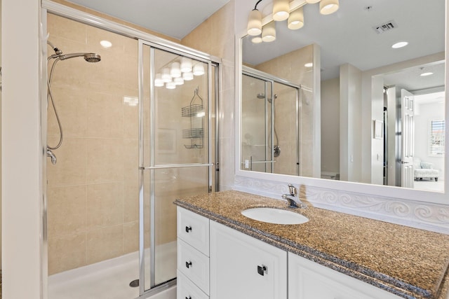 bathroom with vanity and a shower with shower door