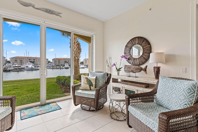 living area with a water view and light tile patterned floors