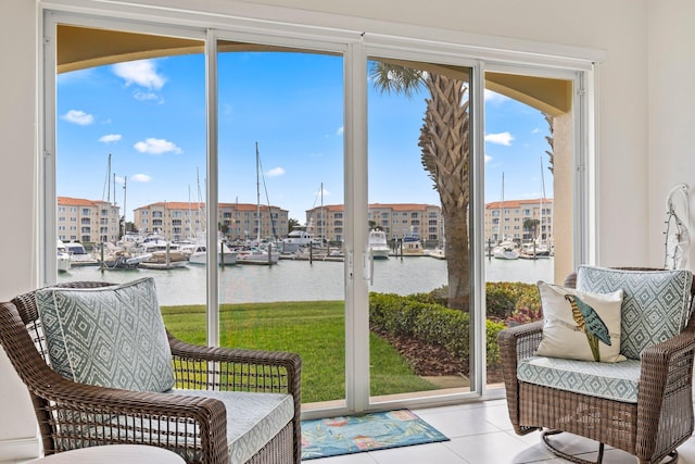 sunroom featuring a water view