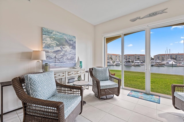 living area with a water view and light tile patterned floors