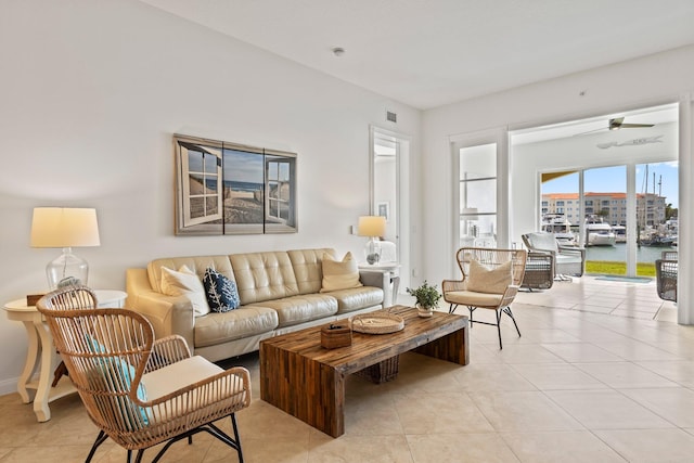 living room featuring a water view and light tile patterned floors