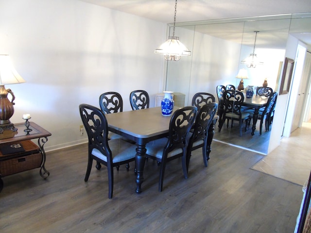 dining area featuring dark wood finished floors and baseboards