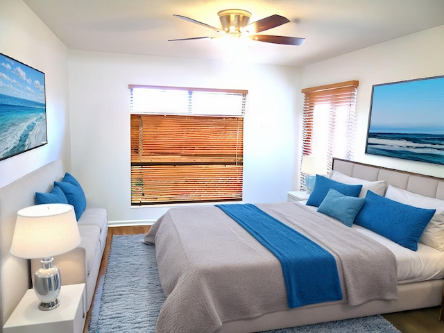 bedroom with ceiling fan and wood finished floors