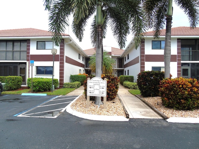 view of property featuring uncovered parking