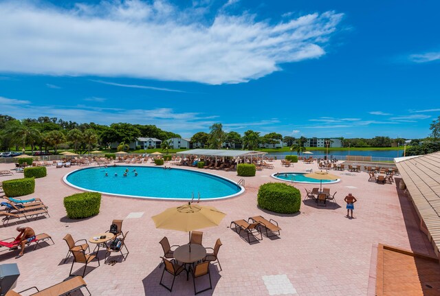 15451 Pembridge Dr Unit 217, Delray Beach, FL 33484 - pool with a patio and a water view