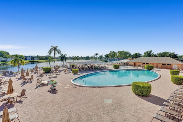 community pool featuring a patio area and a water view