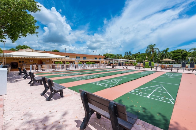 15451 Pembridge Dr Unit 217, Delray Beach, FL 33484 - view of community featuring fence and shuffleboard