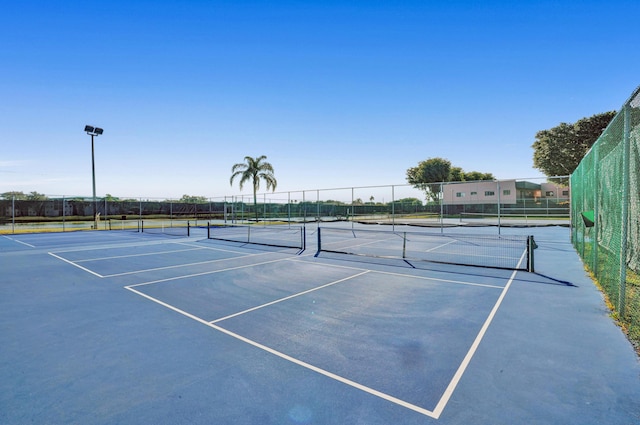 view of tennis court with fence