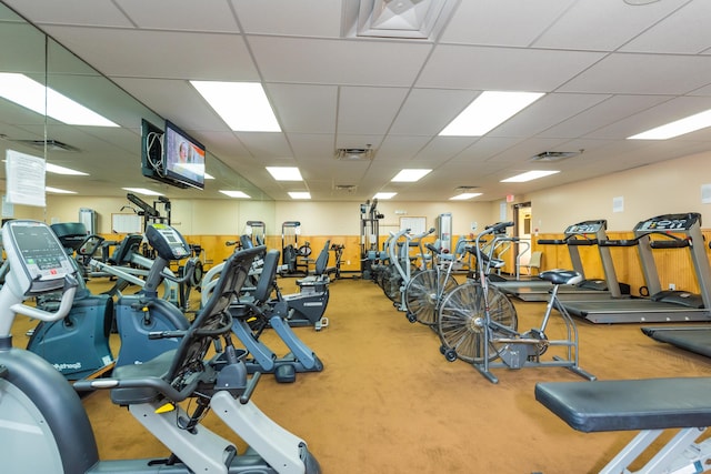 workout area with a drop ceiling and visible vents