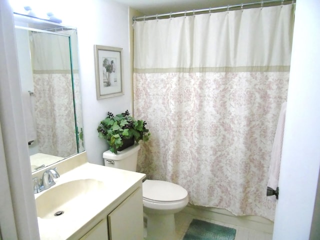 full bathroom featuring toilet, curtained shower, vanity, and tile patterned floors