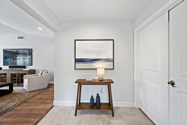 hallway featuring light tile floors