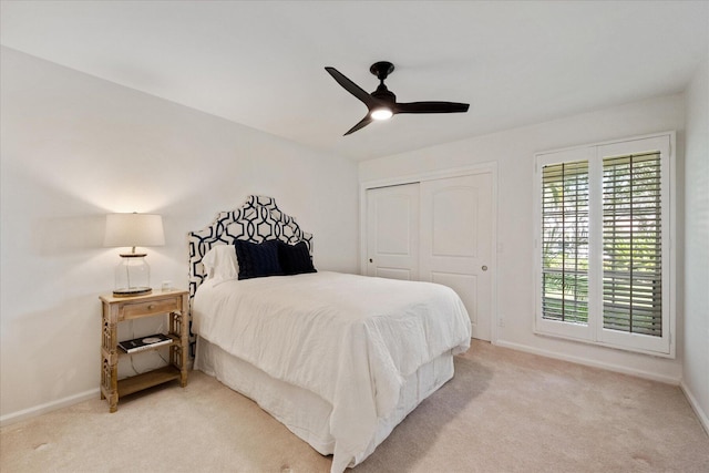 carpeted bedroom with a closet and ceiling fan