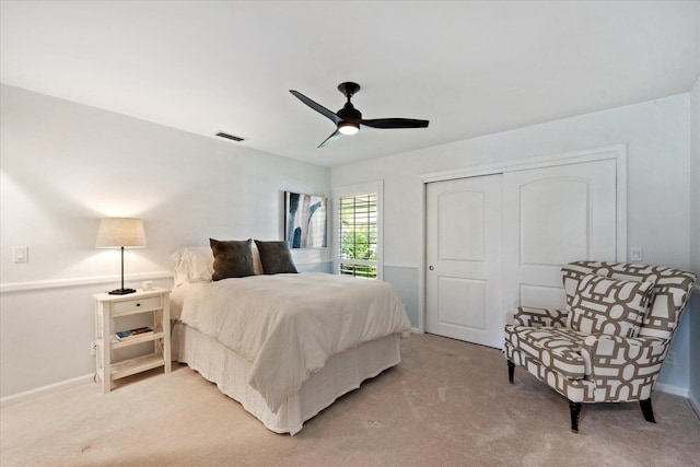 bedroom with a closet, carpet floors, and ceiling fan