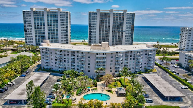 bird's eye view with a water view and a beach view