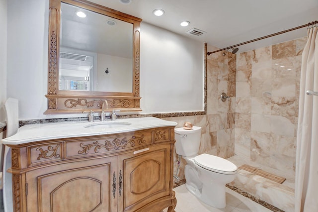 bathroom with toilet, tile walls, vanity, curtained shower, and tile patterned flooring