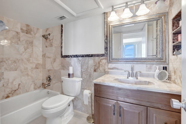 full bathroom with tiled shower / bath, tile walls, vanity, and toilet