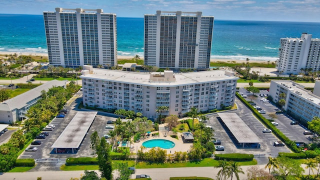 bird's eye view with a water view and a beach view