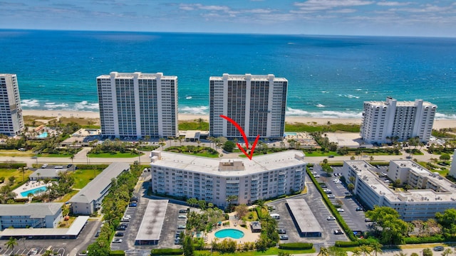 bird's eye view with a water view and a beach view