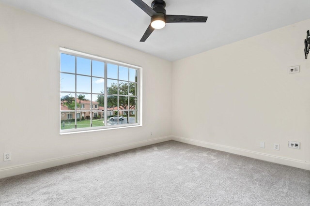 empty room featuring ceiling fan and carpet flooring