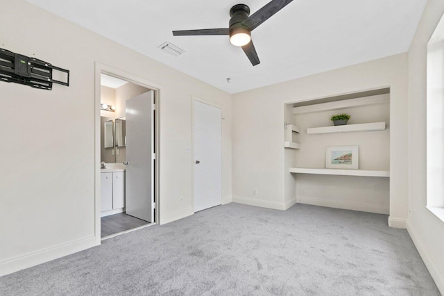 unfurnished bedroom with carpet, ceiling fan, and ensuite bath