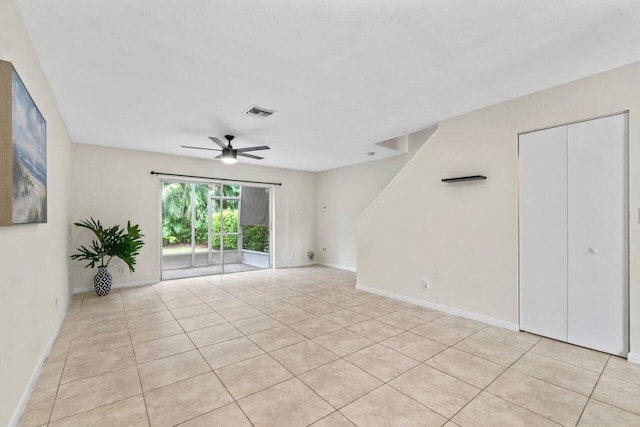 tiled empty room with ceiling fan