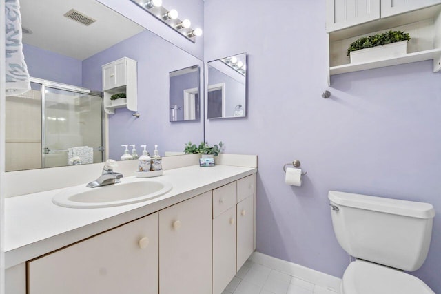 bathroom with tile patterned floors, toilet, an enclosed shower, and vanity