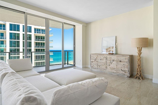 living room with a wall of windows and a water view