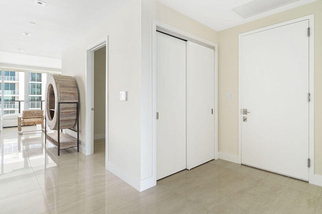 hall featuring light tile flooring